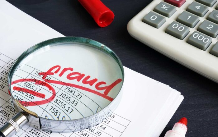 public assistance fraud, fraud written on documents with magnifying glass and calculator