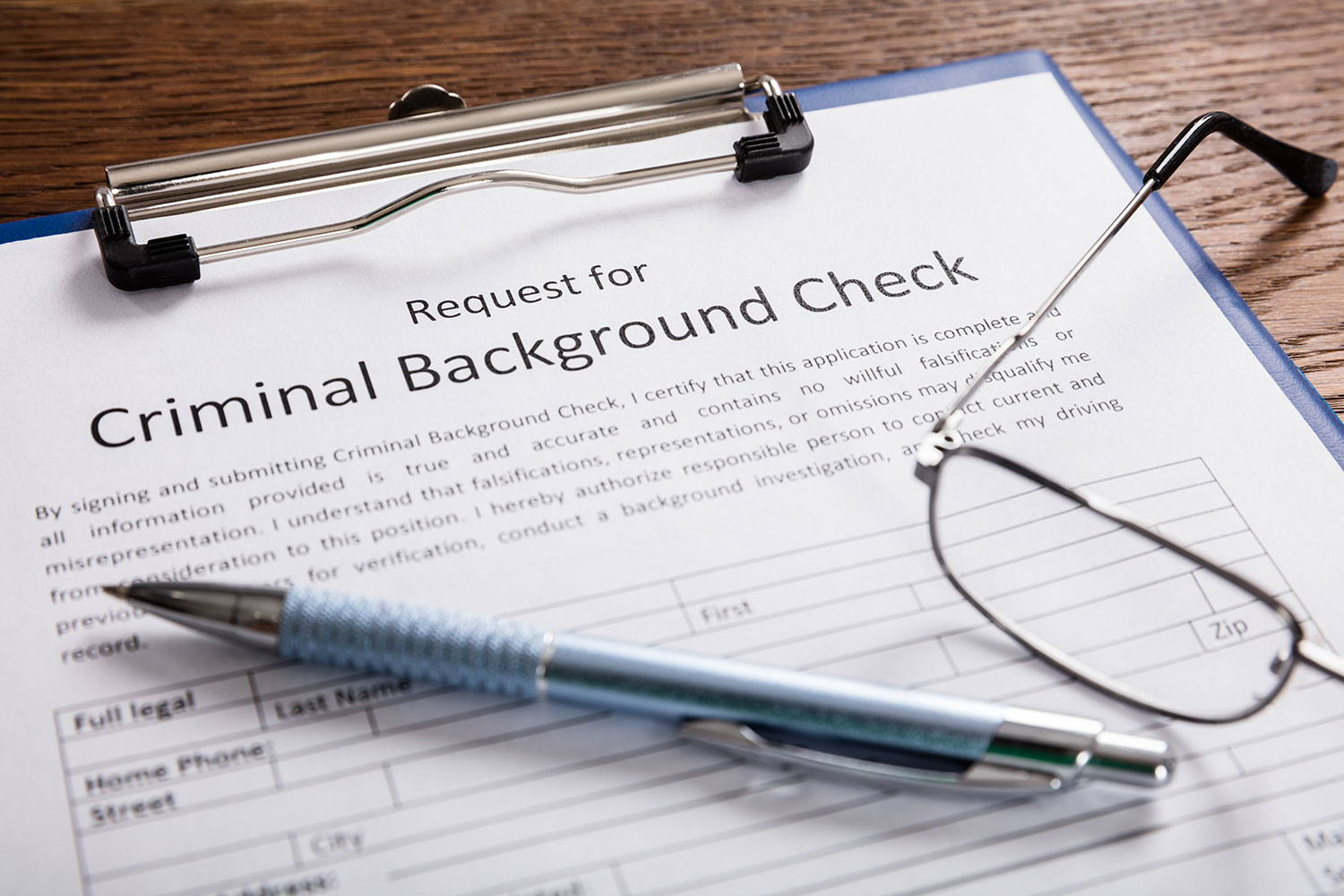 Second Chance Law in Minnesota, Request for Background Check paperwork with pen