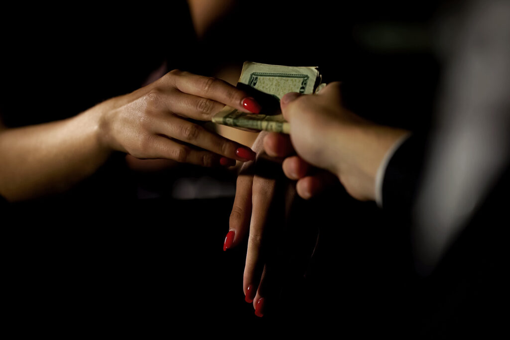 MN Prostitution Laws, woman accepting money from man