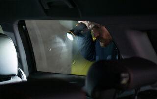 Plain View, man with flashlight looking through vehicle window