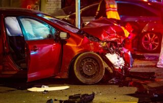 next steps after an auto accident, expert advice from attorneys, crash scene with severe damage to vehicle front and street and other cars in background
