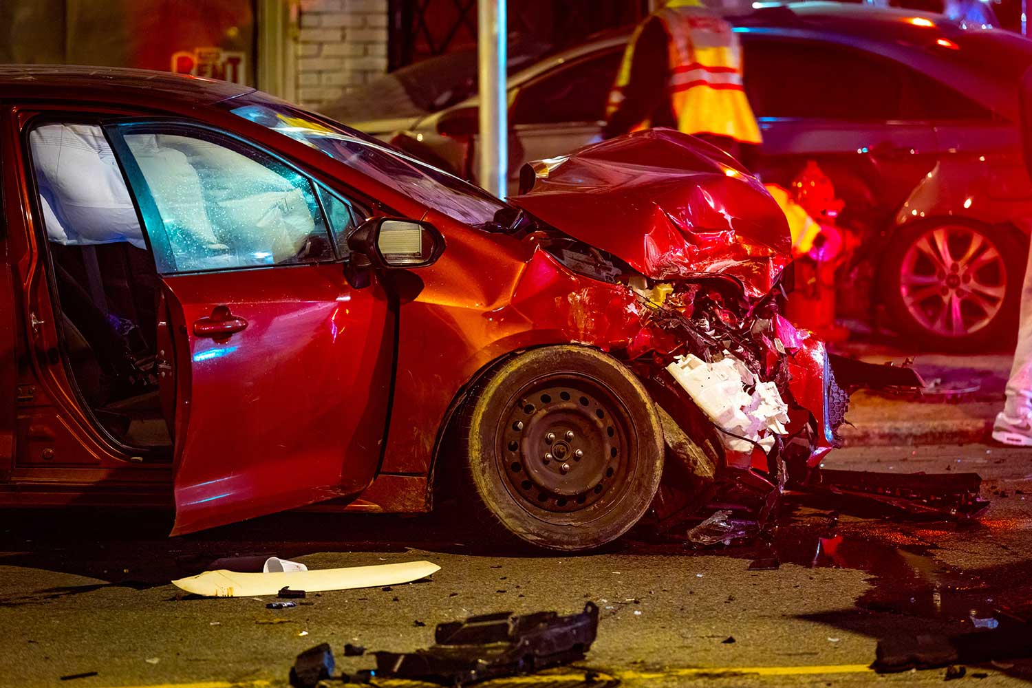 next steps after an auto accident, expert advice from attorneys, crash scene with severe damage to vehicle front and street and other cars in background