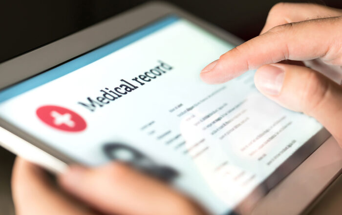 medical record open on tablet, digital file, held by individual reviewing documents