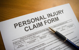 personal injury claim form with pen on wood grain surface